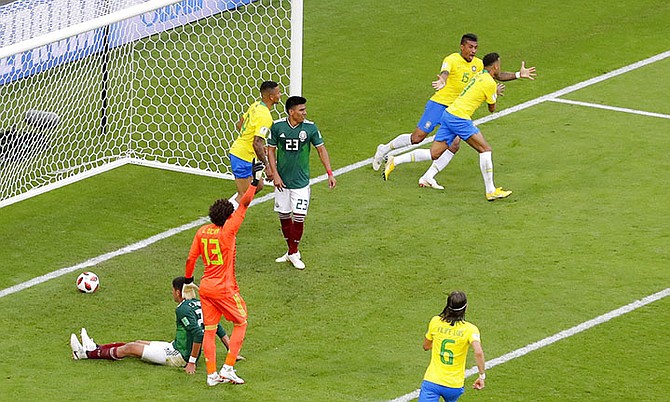 Brazil's Neymar, right, celebrates with his teammates after scoring his side's first goal during the round of 16 match between Brazil and Mexico at the 2018 soccer World Cup in the Samara Arena, in Samara, Russia, Monday.(AP Photo/Sergei Grits)