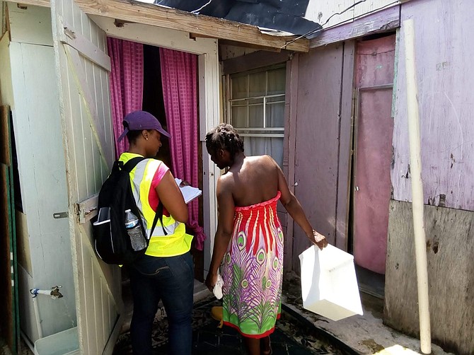 Government representatives canvass shanty town residents in Abaco