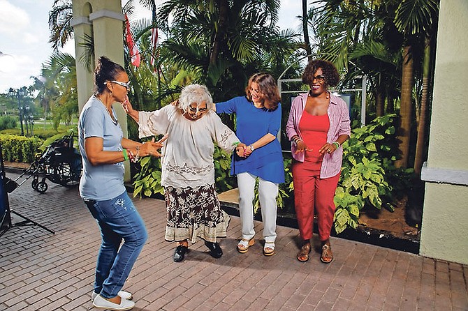 Gussie Taylor-Dennis, 100 years old, shows off her moves with as Hythia Evans, Muna Issa and Denise Taylor look on.

