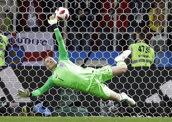 England goalkeeper Jordan Pickford saves a penalty during the round of 16 match between Colombia and England at the 2018 soccer World Cup in the Spartak Stadium, in Moscow, Russia. (AP Photo/Matthias Schrader)