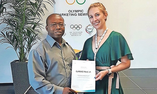 Clarence Rolle pictured receiving the course certificate from Natascha Trittis, Marketing Training Manager of the IOC's Television & Marketing Services unit.