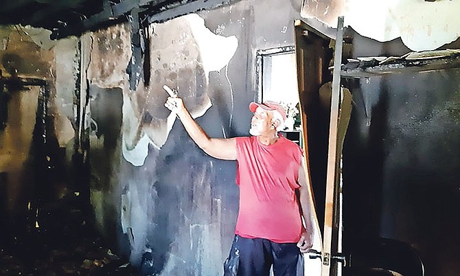 Wayne Smith, son of Doris Smith, shows how a fire ripped through his elderly mother’s bedroom. Photo: Denise Maycock