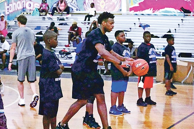 KINGS guard Buddy Hield runs through some drills with the young campers during his fourth Summer Basketball Camp, which is being held in Freeport and Eight Mile Rock, Grand Bahama.