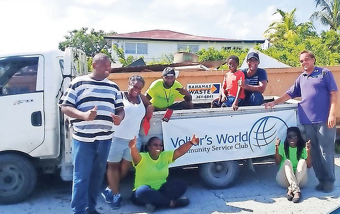 The executive members of Voltar’s World on-site at Millar Heights posing in front of a Bahamas Waste bin. 