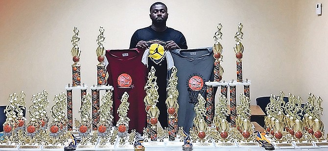 JABARI Wilmott stands beside the awards and jerseys for the Fox Hill Festival ‘Hooping by the Park’ that starts tonight at Freedom Park, Fox Hill.