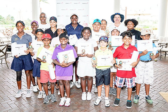JOB WELL DONE: Young, aspiring golfers can be seen with the trophies and certificates they won in this year’s Bahamas First Junior Open.