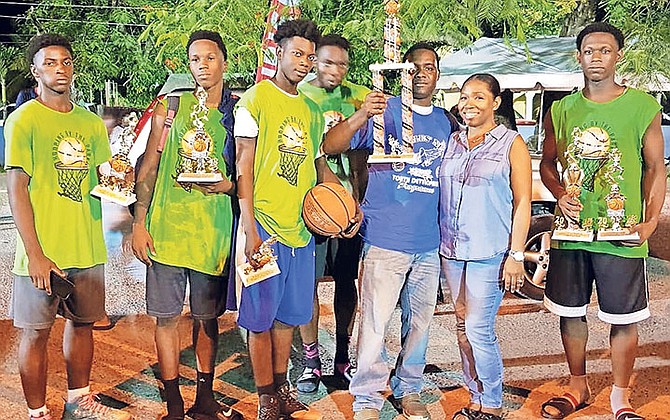 Eagles Nest players celebrate winning the Hooping by the Park under-19 basketball title.