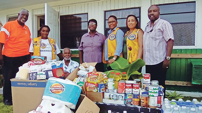 Members of the Lions Club of Freeport donated items to Rabertha Senior Citizens Home. Seen second from right is president Gwen Symonette-Pinder and administrator Albertha Hudson, fourth from right, and a resident, Granville Johnson. Photo: Denise Maycock/Tribune Staff