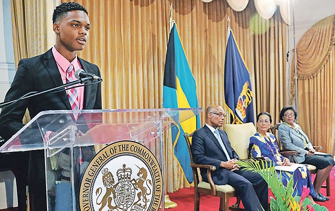 All-Bahamas Merit Scholar 2018 Aaron Edgecombe addresses the All-Bahamas Merit and National Merit Scholars Award Ceremony at Government House on August 9. Pictured at right: Minister of Education Jeffrey Lloyd, Governor General Dame Marguerite Pindling, and Ministry of Education Permanent Secretary Lorraine Armbrister. Photo: Derek Smith/BIS

 

 