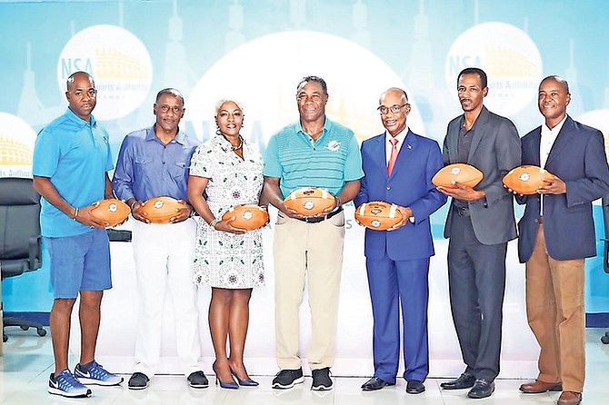 THE MIAMI Dolphins hosted a press conference yesterday at the Thomas A. Robinson National Stadium to make a donation of 48 footballs and 20 ladders to The Bahamas. Pictured from (L-R) are: Jayson Clarke, Bahamas Flag Football League President; Jeff Rodgers, Sports Tourism; Eldese Clarke, Sports Tourism; Nat Moore, Senior Vice President of Special Projects & Alumni Relations at Miami Dolphins Ltd.; Jeff Lloyd, Minister of Education; Tim Munnings, Director of Sports and Antonio Maycock, President of the Commonwealth American Football League. Photo: Shawn Hanna/Tribune Staff 