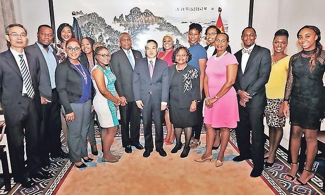 Chinese Ambassador Huang Qinguo, centre, with Permanent Secretary at the Ministry of Foreign Affairs Jack Thompson, other officials and Bahamian recipients of Chinese scholarships at a recent reception at the Chinese Embassy. Photo: Eric Rose/BIS