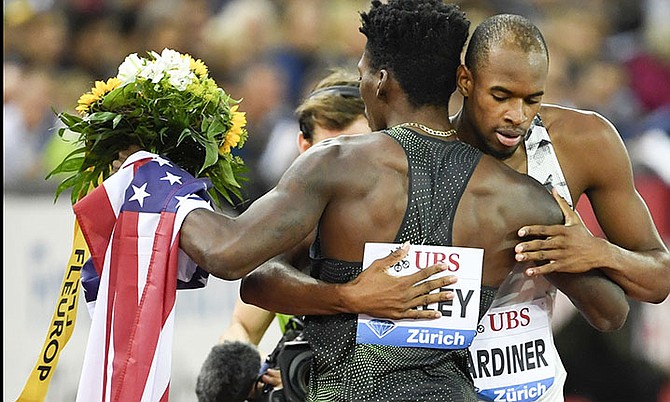 The United States' Fred Kerley, back to camera, is congratulated by Steven Gardiner from the Bahamas after winning the men's 400m race, during the Weltklasse IAAF Diamond League international athletics meeting in the Letzigrund stadium in Zurich, Switzerland, Thursday. (Jean-Christophe Bott/Keystone via AP)


