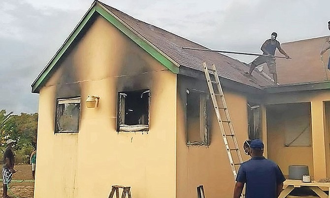 A picture from social media reportedly showing people tackling the blaze at Rum Cay All-Age School.