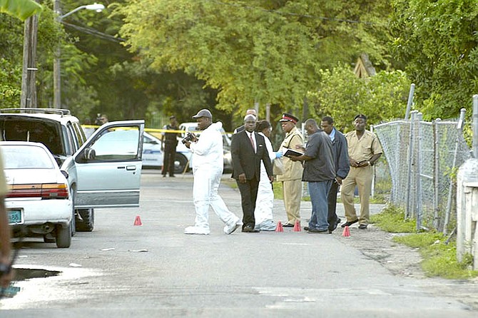Police at the scene of the shooting on Plantol Street. Photo: Terrel W Carey/Tribune staff