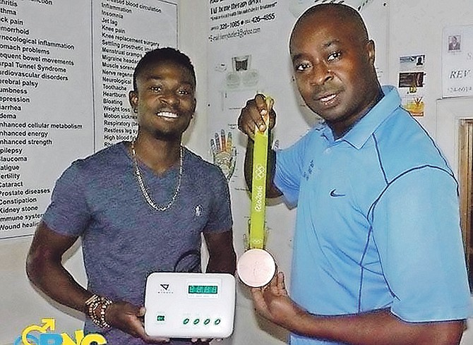 Alonzo Russell, silver medallist in the 4x400m in 2016 World Indoors and bronze medallist in the Rio de Janeiro Olympics, with Henry A Butler and his TAB device. 

