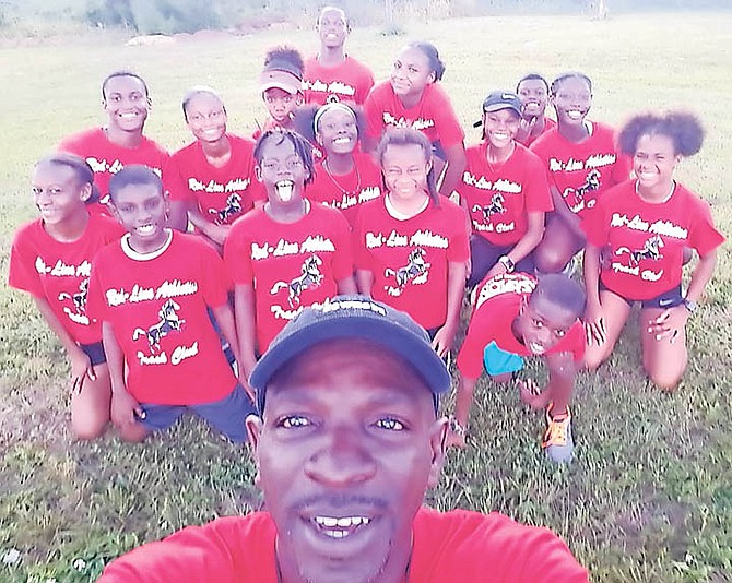 Head coach Tito Moss takes a selfie in front of members of the newly formed Red Line Athletics Track Club.