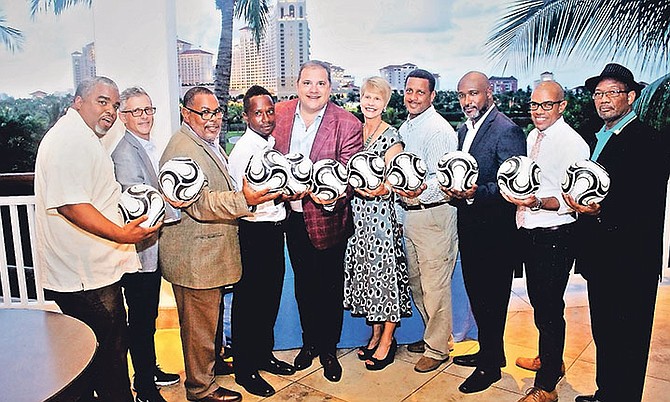 CONCACAF president Victor Montagliani (fifth from left) presents commemorative soccer balls to BFA coaches.