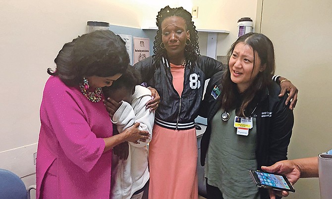 Taranique Thurston is comforted by US Congresswoman Frederica Wilson alongside her mother, Ginette Caty, and Miami doctor Deborah Soong yesterday. Photo: Ava Turnquest/Tribune Staff