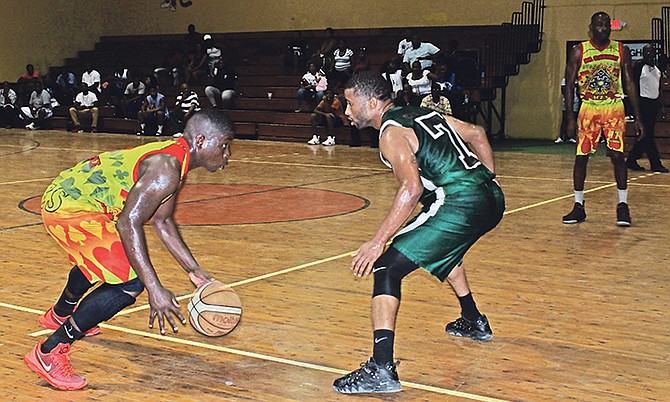 Cabinet Aces' guard Patrick Brice dribbles against the defence of RBDF's Marine Mechanic Raynold Culmer.