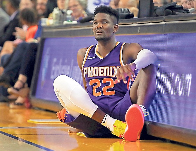 Phoenix Suns’ Deandre Ayton, of the Bahamas, waits on the sideline during the second half of a preseason game against the Golden State Warriors on Monday in Oakland, California. At the federal trial into NCAA corruption, Ayton was named as one of several former players to receive improper benefits.