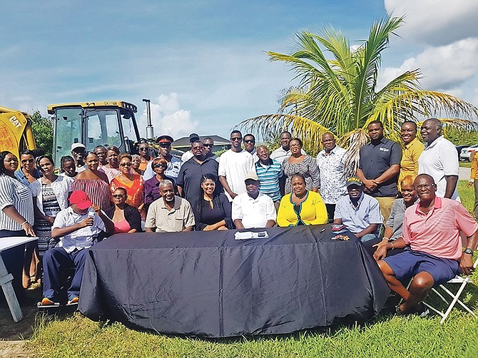 Seated second from left, widow Earlene Stubbs, who is next to her son seated left, of the Seagrape community. Mrs Stubbs and her family were displaced when her home was destroyed by a hurricane in 2016. The community has come together to help rebuild her home. 

 