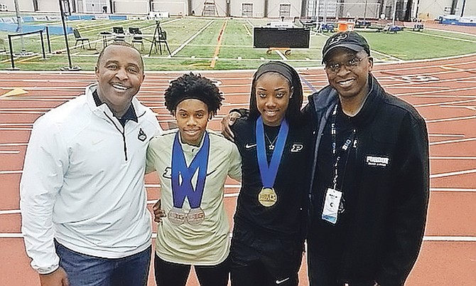 Rolando 'Lonnie' Greene (left) is shown with athletes Devyenne Charlton and Carmiesha Cox and coach Norbert Elliott.