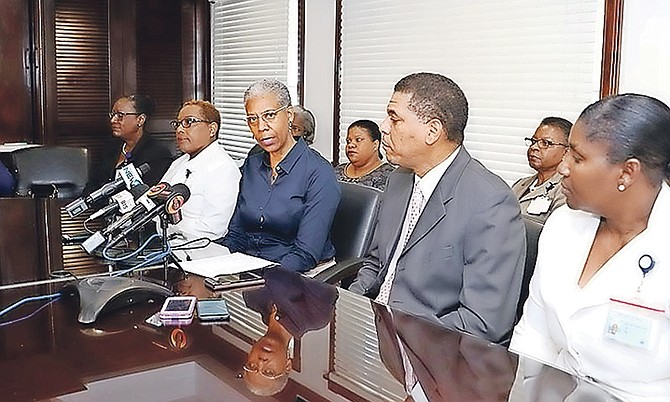 Catherine Weech, managing director, Public Hospitals Authority, (third from left) announces a new shift system for nurses yesterday. Seated from left, nursing services advisor Lillian Black-Charlton; Valerie Miller, principal nursing officer, Princess Margaret Hospital; Mrs Weech; deputy managing director, PHA, Lyrone Burrows and Thelma McKenzie. principal nursing officer, Sandilands Rehabilitation Centre.  
Photo: Raymond A Bethel Sr/BIS