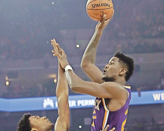 Phoenix Suns centre Deandre Ayton, right, shoots against Golden State Warriors centre Damian Jones in the first half on Monday night in Oakland, California. The Warriors won 123-103.

(AP Photo/Jeff Chiu)

 