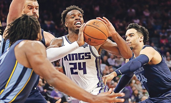 TRIPLE TEAM: Kings guard Buddy Hield, centre, passes as he is triple-teamed by Memphis Grizzlies’ Wayne Selden, left, Marc Gasol, second from left, and Dillon Brooks in the second half Wednesday night in Sacramento, California. The Kings won 97-92.

(AP Photo/Rich Pedroncelli)

 