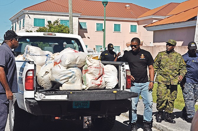Law enforcement officers after seizing over $1m worth of suspected marijuana after a high speed boat chase in Grand Bahama. 