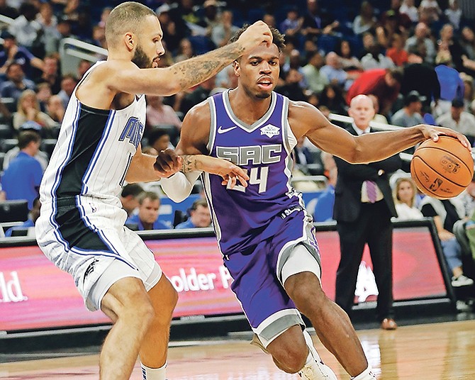 Sacramento Kings’ Buddy Hield (24) drives around Orlando Magic’s Evan Fournier, left, in the first half on Tuesday night.

(AP Photo/John Raoux)