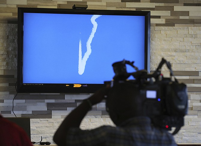 A NASA image of a F/A-18 performing a Sonic Boom over Edwards Air Force Base in California, is shown on a TV screen in Galveston, Texas. NASA has begun a series of supersonic research flights off the Texas Gulf Coast near Galveston to test how the community responds to noise from a new experimental aircraft.