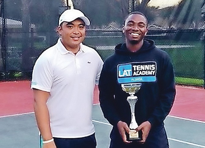 Kevin Major Jr holding his trophy with his coach Lawrence Carpio.