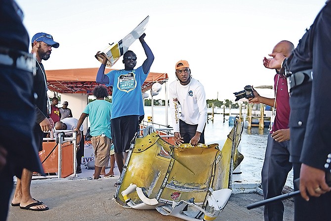 Volunteer efforts, organised by Gina Knowles, recovered parts of the plane. Photo: Shawn Hanna/Tribune Staff