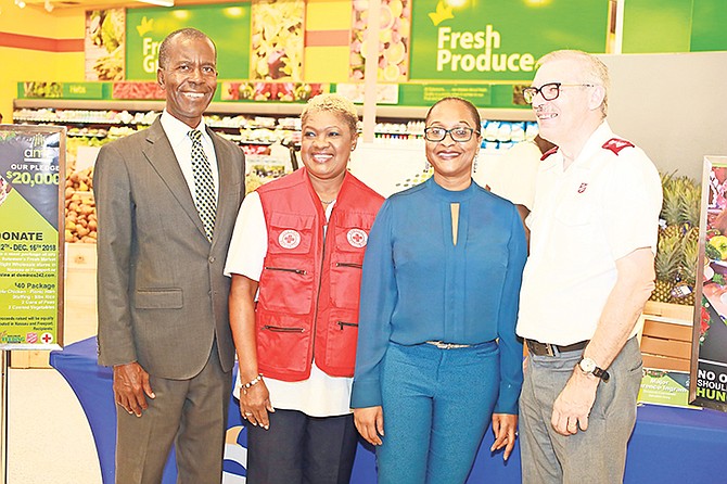 At the AML Foods press conference at Solomons Fresh Market East are, from left, Philip Smith (executive director of Bahamas Feeding Network) Janice Bain-Mackey (HR & logistics manager of The Bahamas Red Cross), Renea Bastian (VP marketing & communications of AML Foods Ltd), and Major Clarence Ingram (divisional commander of the Salvation Army).

Photo: Donavan McIntosh