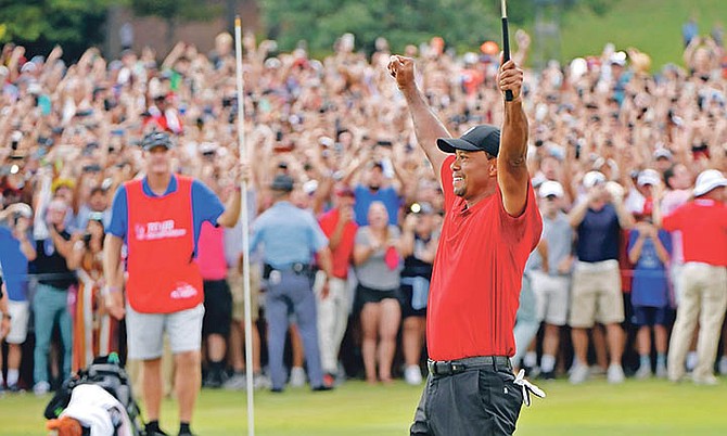 Tiger Woods celebrates on the 18th green after winning the Tour Championship golf tournament on September 23. (AP)