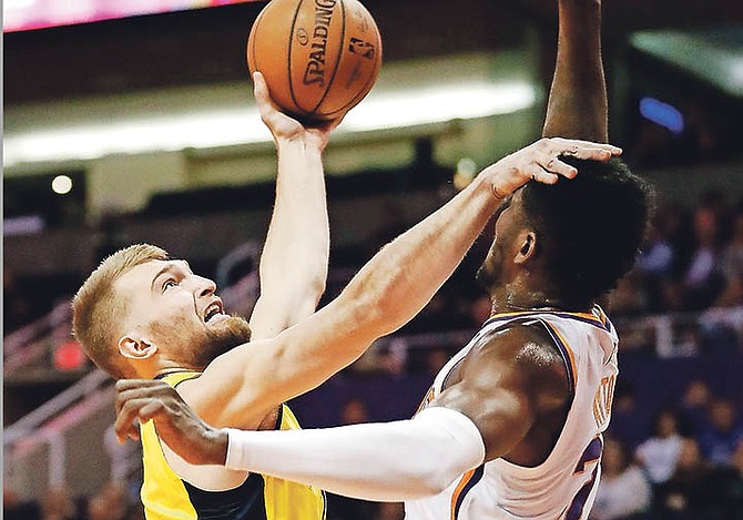 Pacers forward Domantas Sabonis shoots over Phoenix Suns centre Deandre Ayton, right, during the first half Tuesday night in Phoenix.