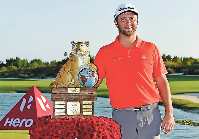 Jon Rahm, of Spain, poses with the tournament trophy after winning the Hero World Challenge at Albany Golf Club yesterday.

(AP Photo/Dante Carrer)