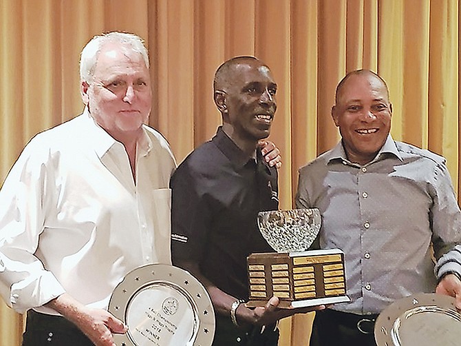 JOB WELL DONE: Shown (l-r) are Bahamas team members Steve Wallace, Anthony Hinsey, manager/coach, and Kevin Marche with their trophies.