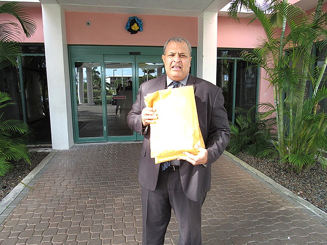 Pastor Eddie Victor delivering copies of the letters of support signed by citizens from East Grand Bahama, to the office of the constituency office of Deputy Prime Minister and Member of Parliment K. Peter Turnquest.