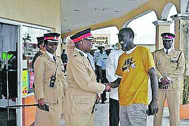 Police patrol shops in Grand Bahama. Photo: Vandyke Hepburn