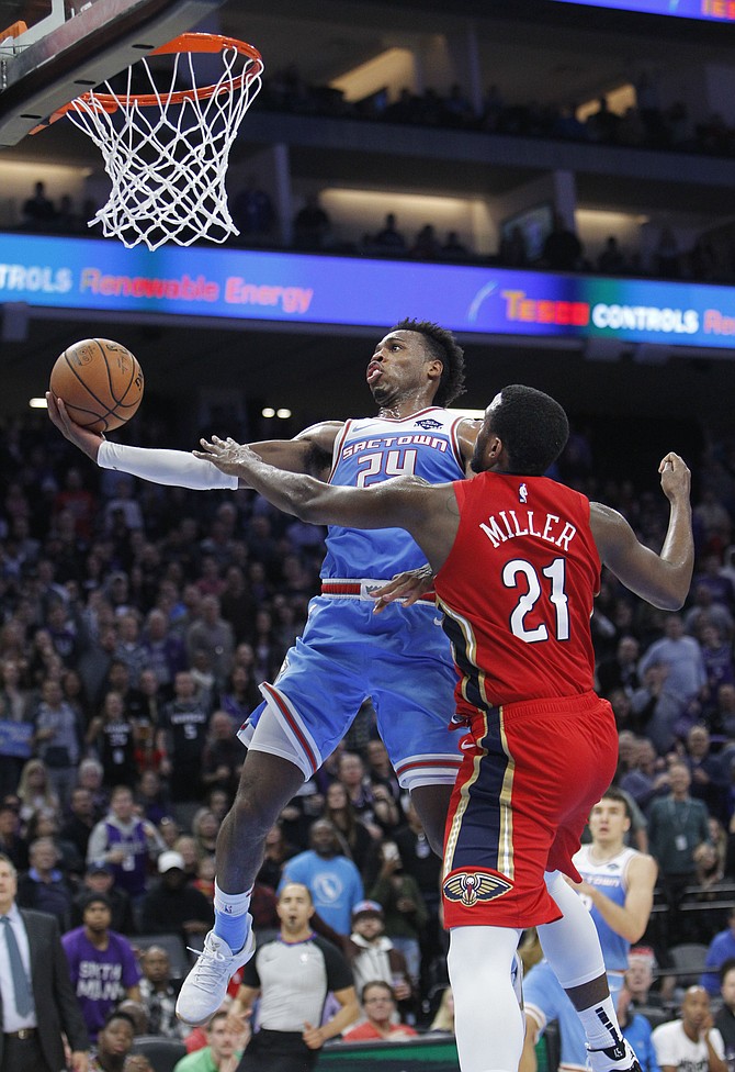 Kings guard Buddy Hield (24) drives to the basket against New Orleans Pelicans forward Darius Miller (21) during the second half on Sunday.