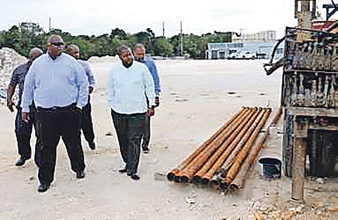 Adrian Gibson, Water and Sewerage Corporation executive chairman, is pictured (right, front row) inspecting the site for a new reverse osmosis plant in North Eleuthera. Also shown (front, left) is Gaddy Senatus, service manager, Suez Aqua Design Bahamas Ltd; back row from left, Thomas Desmangles, distribution operations manager; Cyprian Gibson, assistant general manager and Elwood Donaldson, general manager.

Photo: Patrick Hanna/BIS