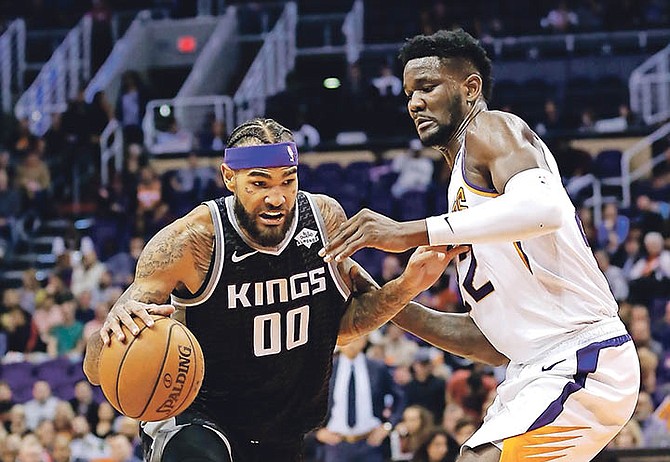 Sacramento Kings centre Willie Cauley-Stein (00) drives to the basket against Phoenix Suns centre Deandre Ayton in the first half last night in Phoenix.

(AP Photo/Rick Scuteri)