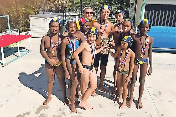 MAKING A SPLASH: Bahamas Mantas Water Polo Club members with their trophy and gold medals won at the South Florida Under-12 Winter Cup at the Pompano Beach Swimming Pool in Fort Lauderdale, Florida.
