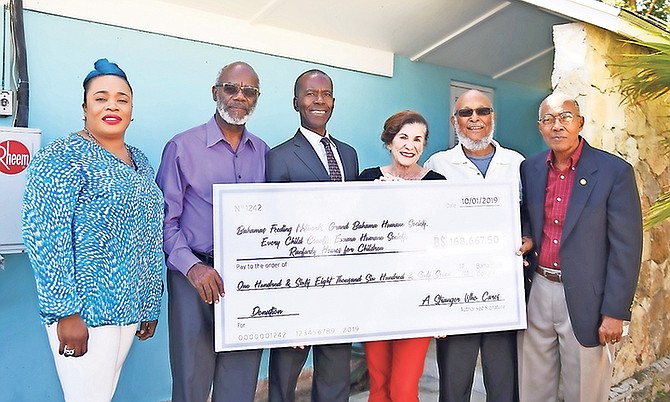 Anonymous doner bestows $168,000 to five Bahamian charities. Pictured, from the left, are Eldri Ferguson-Mackey, DPA partner; L Alexander Roberts, Ranfurly Home administrator; Philip Smith, Bahamas Feeding Network Executive Director; Diane Phillips, DPA president; Joseph Darville, Humane Society Grand Bahama President and Dr Colin Archer, Every Child Counts in Abaco representative. Photos: Shawn Hanna/Tribune Staff