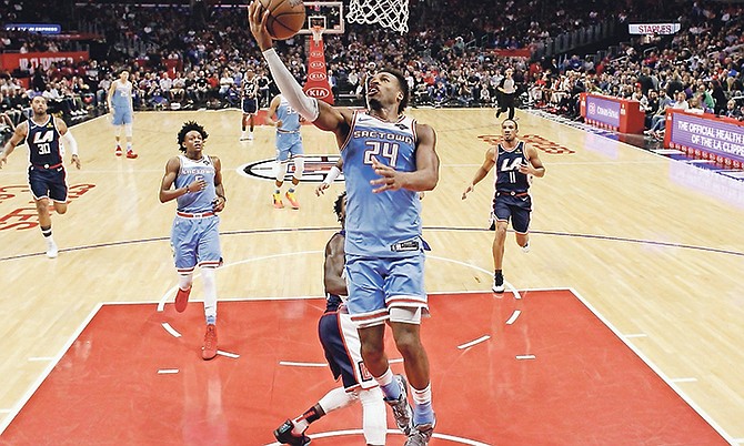 Sacramento Kings’ Buddy Hield (24) scores against the Los Angeles Clippers during the first half Sunday in Los Angeles.
(AP Photo/Marcio Jose Sanchez)