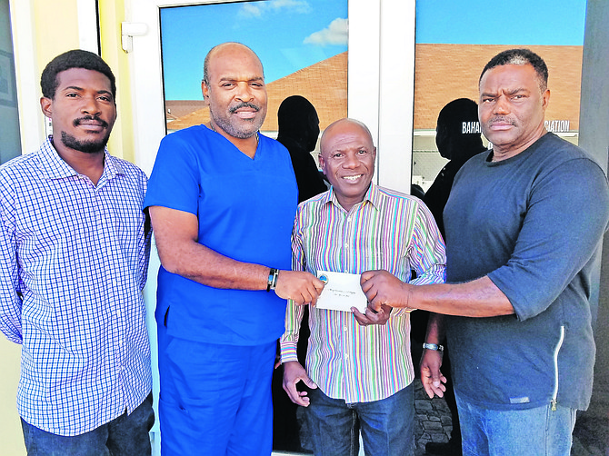 A cheque is presented to Eugene Thurston of the Bahamas Diabetic Association.