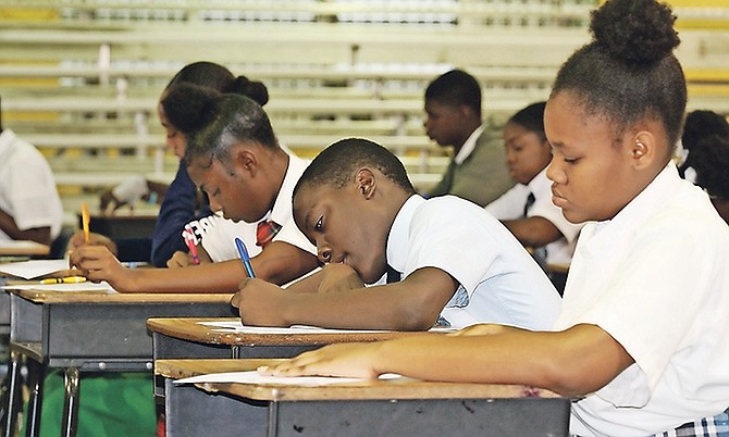 Students get to work at essay writing competition. Photo: Koy Martin