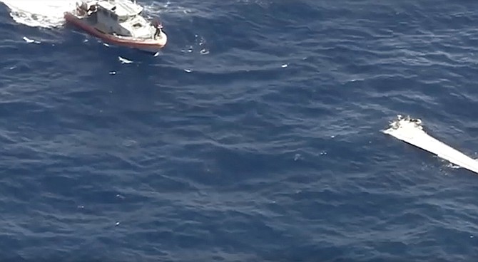 A still from video footage showing a wing from the aircraft on the water.